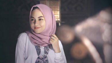 A serene portrait of a woman wearing a pink hijab, exuding grace and elegance.